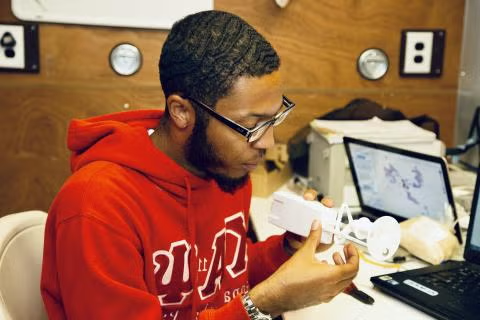 NSF NCAR researcher working with weather instrument